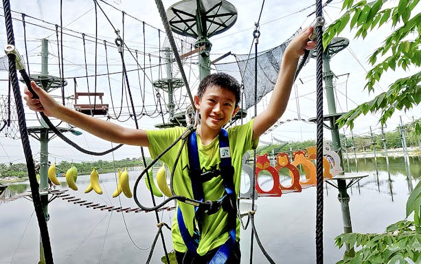 Child navigating ropes course at ESCAPE Ipoh Theme Park, Malaysia.