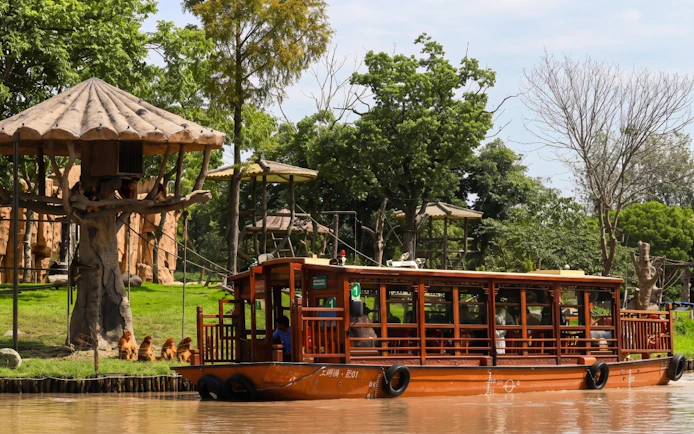 Boat tour passing animal enclosures at Shanghai Wild Animal Park.
