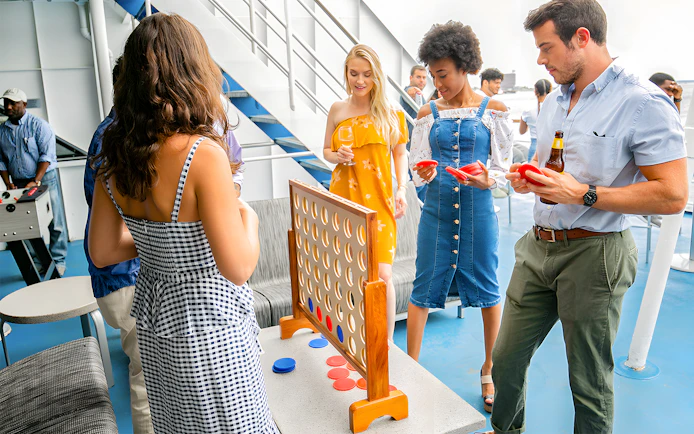 Guests playing a game on the deck during New York Signature Dinner Cruise.