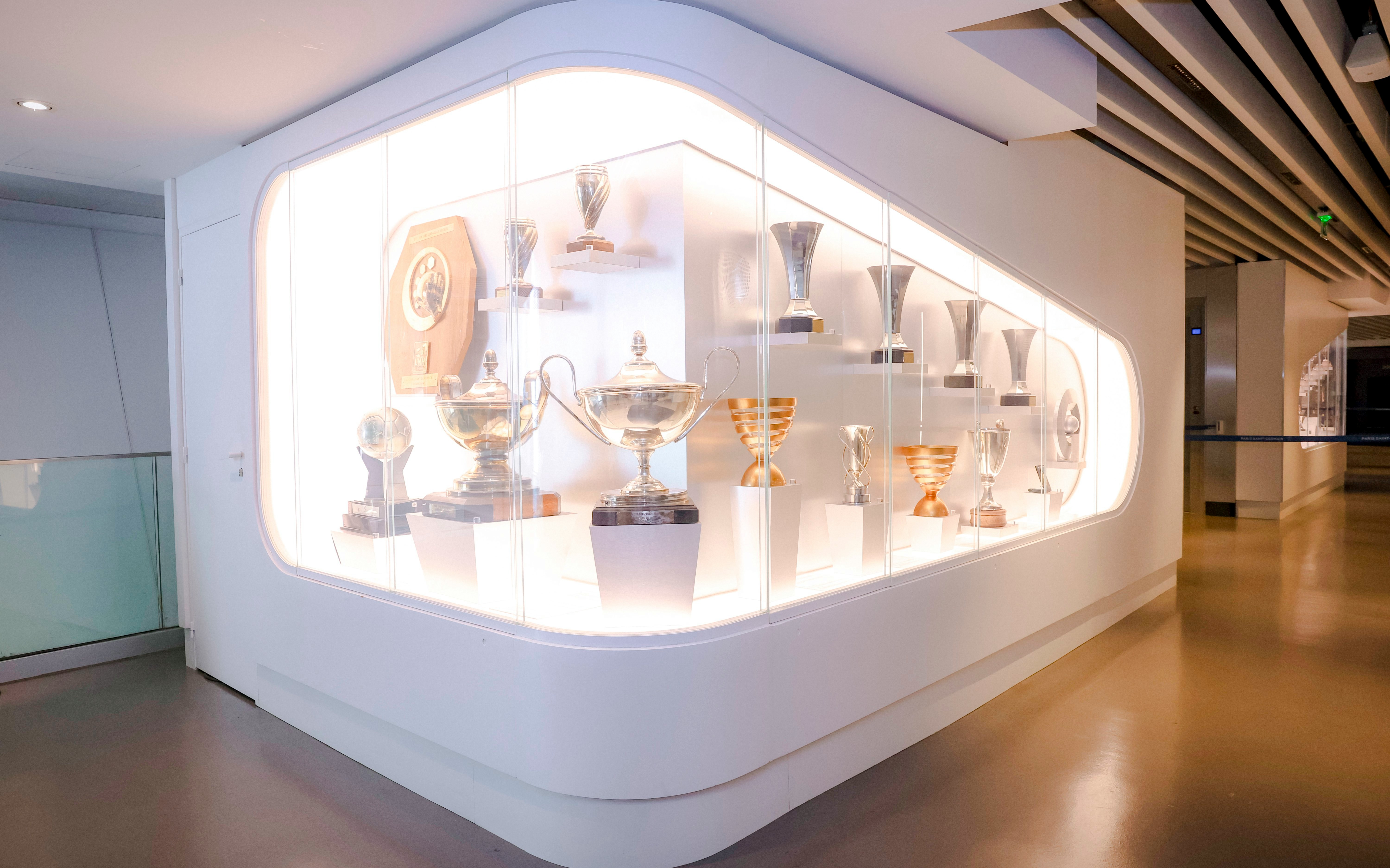 Trophy display at PSG Stadium, Paris, France showcasing various football awards.
