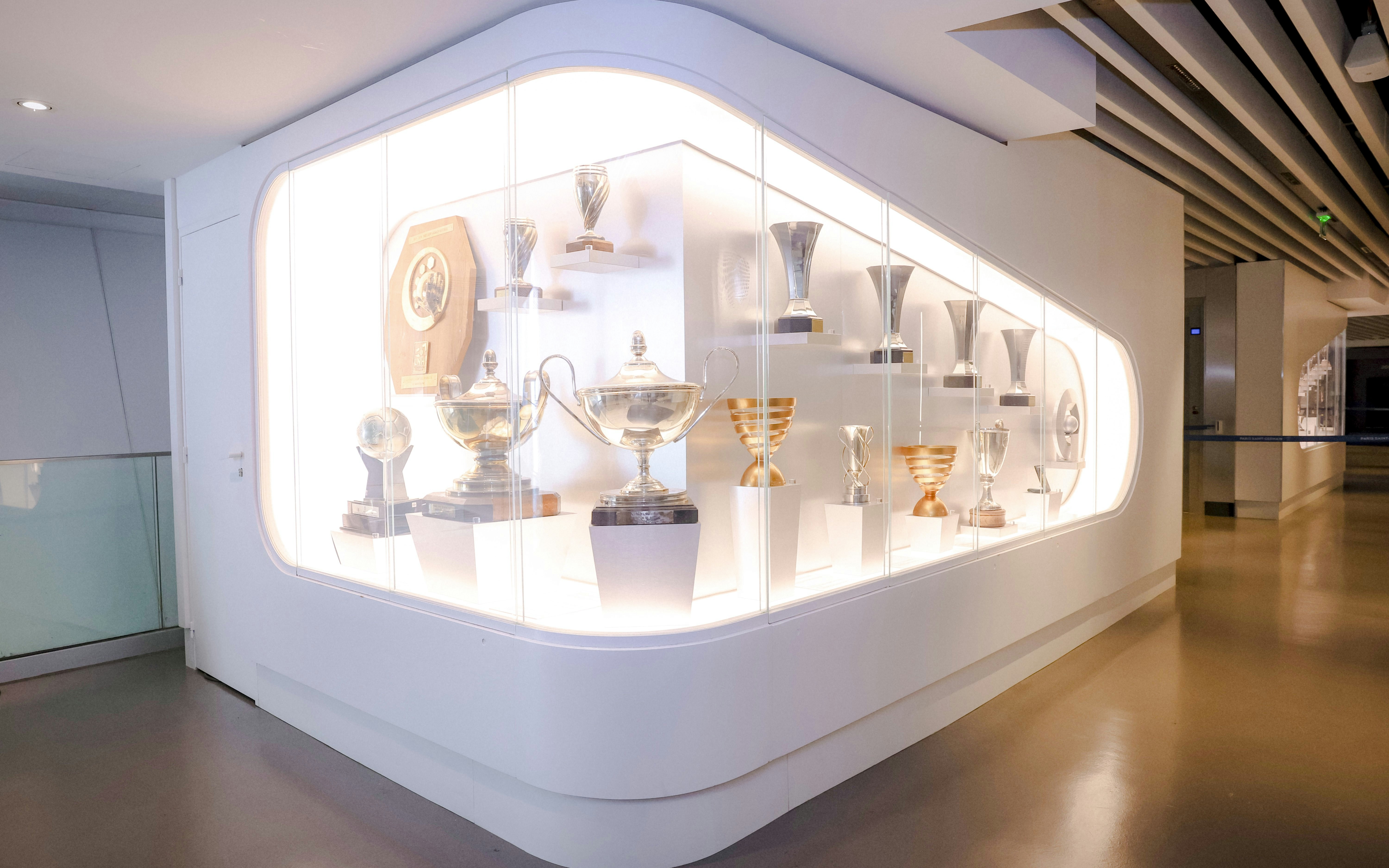 Trophy display at PSG Stadium, Paris, France showcasing various football awards.