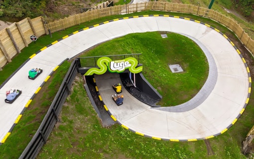 Aerial view of luge track with riders at Skyline Luge, Kuala Lumpur.