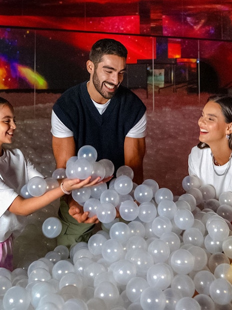 Family enjoying interactive ball pit at AYA Universe.