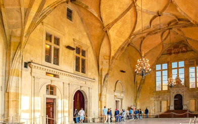 Visitors touring the historic Vladislav Hall inside Prague Castle.