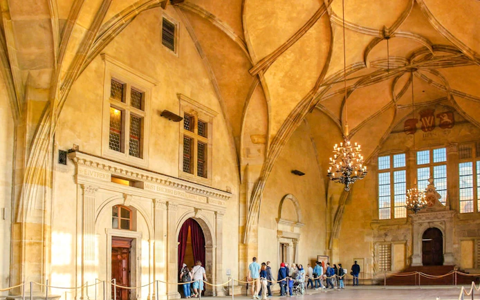 Visitors touring the historic Vladislav Hall inside Prague Castle.