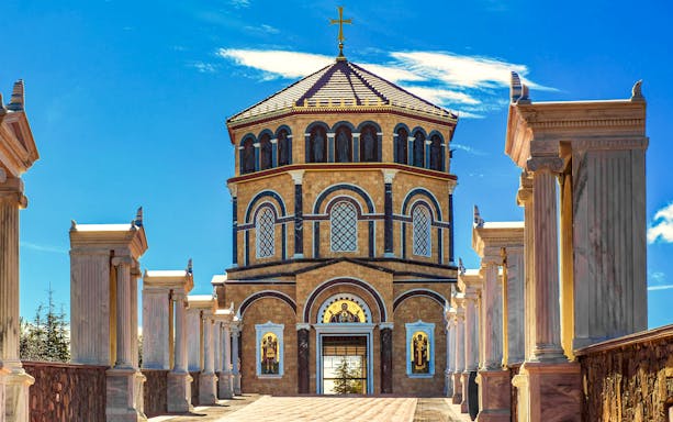 Kykkos Monastery entrance with columns and religious icons in Cyprus.