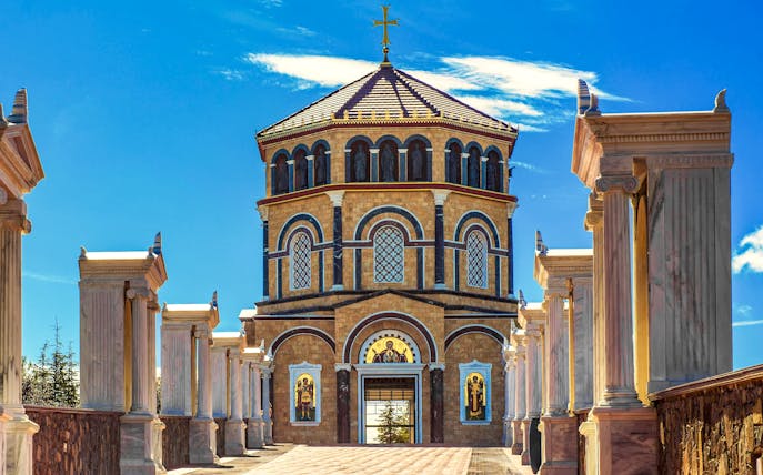 Kykkos Monastery entrance with columns and religious icons in Cyprus.