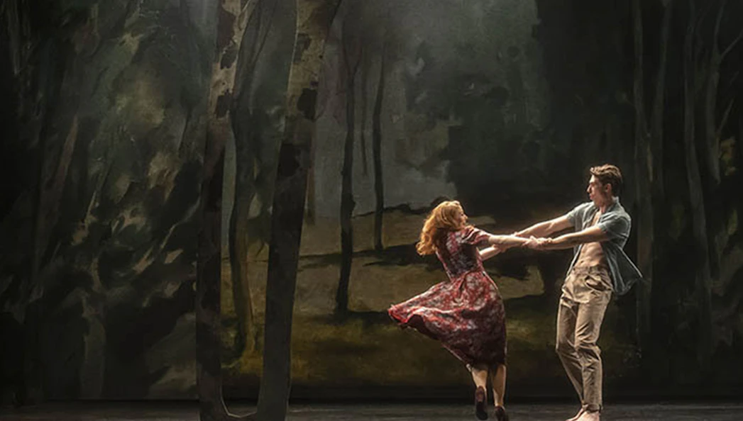 Dancers performing in a forest-themed set for "Aspects of Love" show.