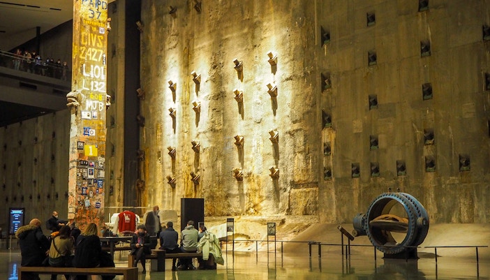 9/11 Museum entrance with visitors exploring exhibits in New York City.