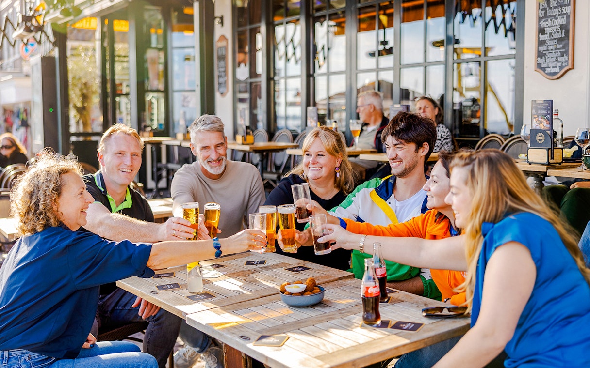 Guests enjoying drinks at a café in Volendam during the Zaanse Schans Tour.