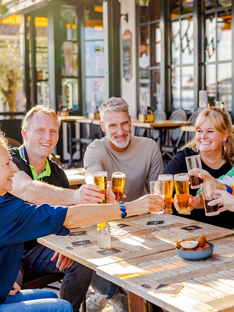 Guests enjoying drinks at a café in Volendam during the Zaanse Schans Tour.