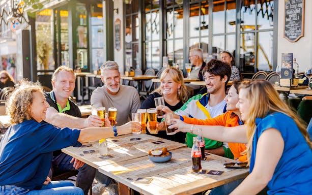 Guests enjoying drinks at a café in Volendam during the Zaanse Schans Tour.