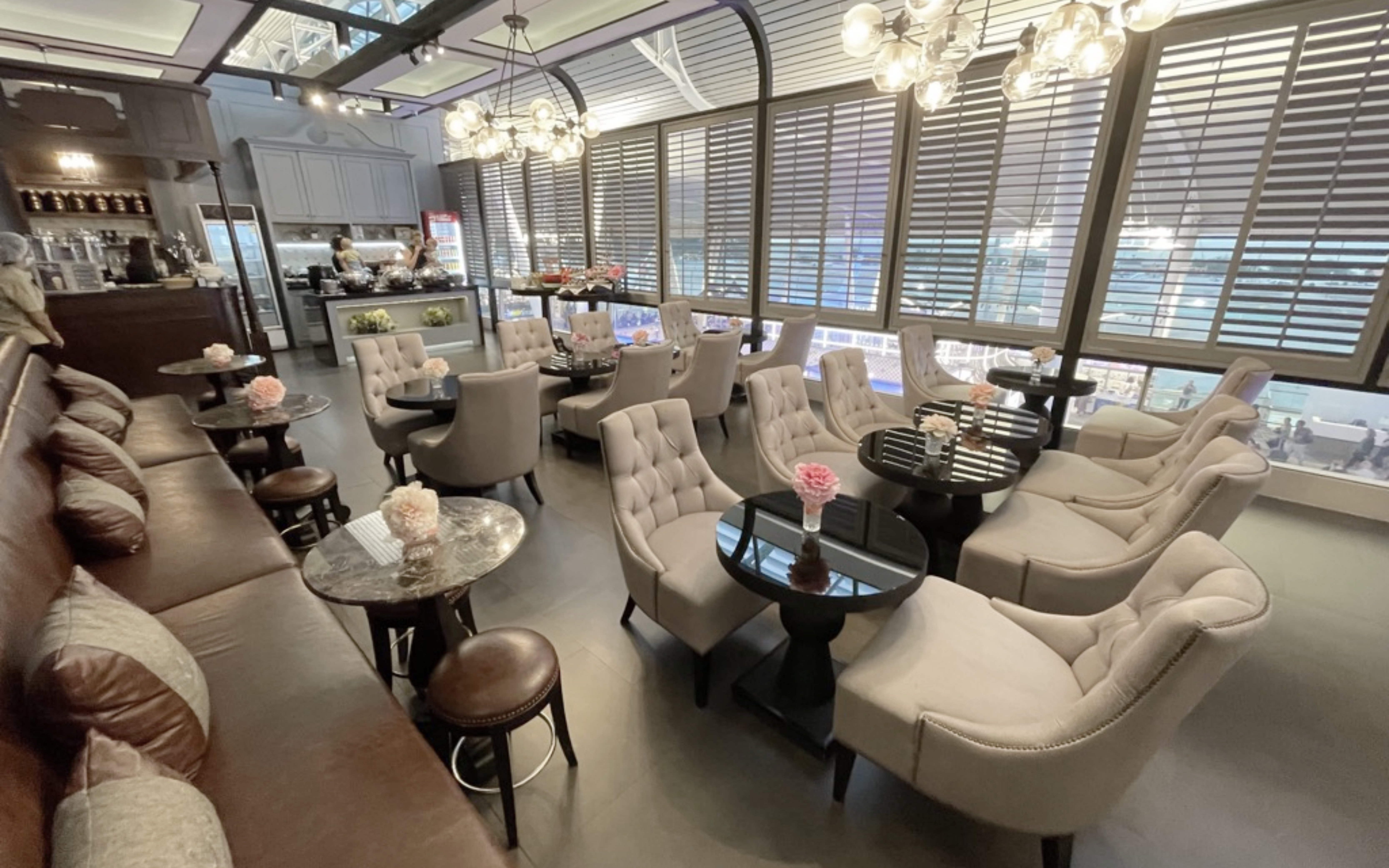Coral First Class Lounge seating area at Phuket International Airport with plush chairs and tables.