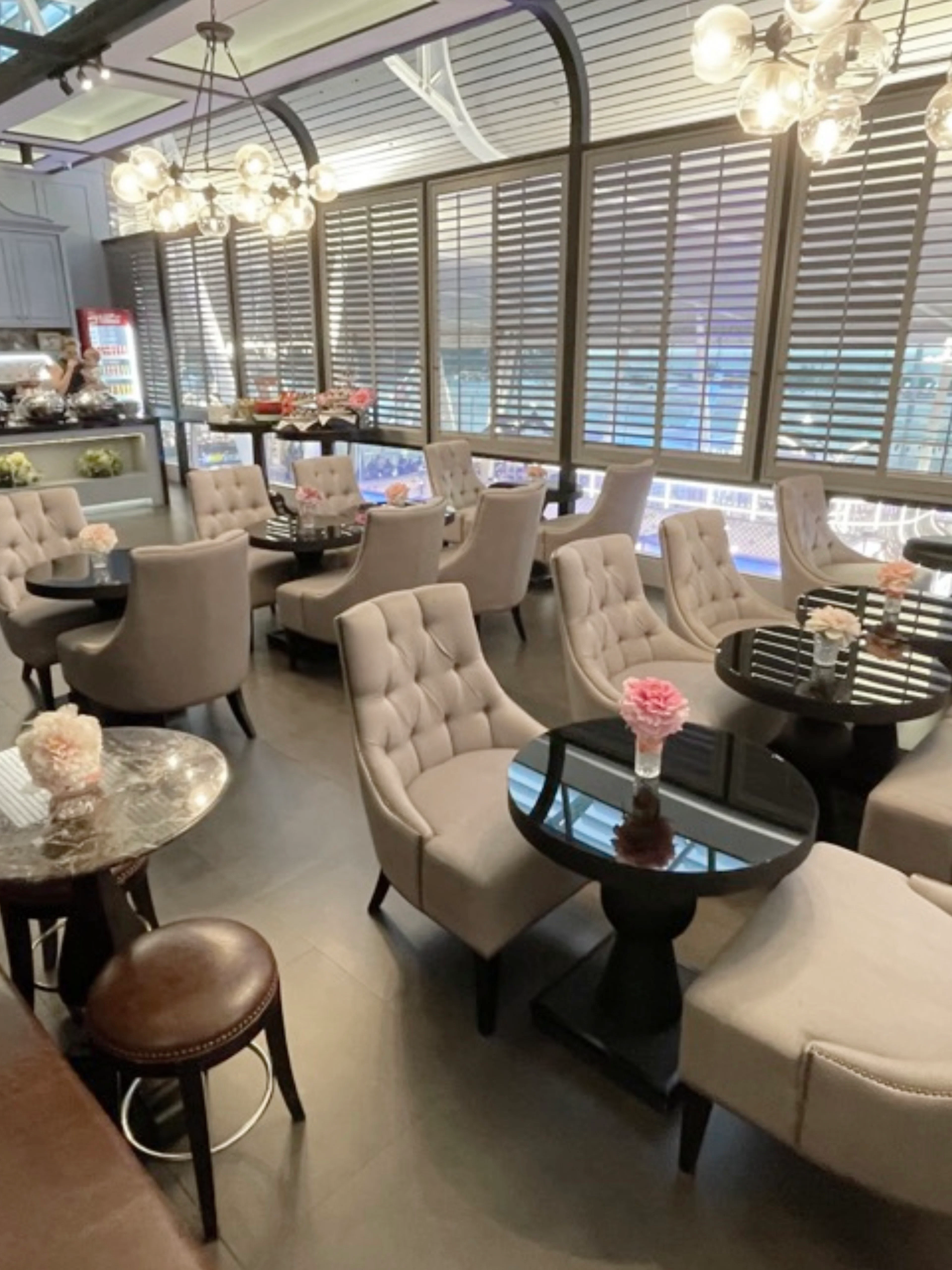 Coral First Class Lounge seating area at Phuket International Airport with plush chairs and tables.