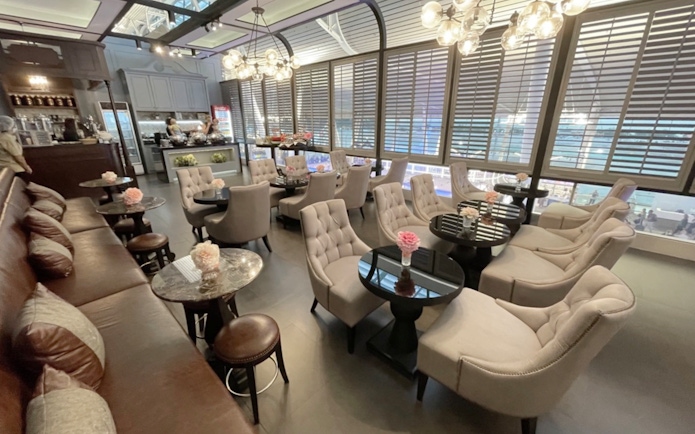Coral First Class Lounge seating area at Phuket International Airport with plush chairs and tables.