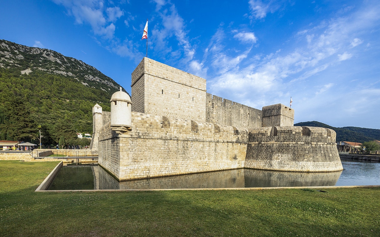 Walls of Ston in Croatia with stone fortifications and surrounding landscape.