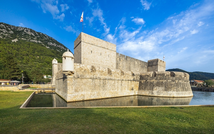 Walls of Ston in Croatia with stone fortifications and surrounding landscape.