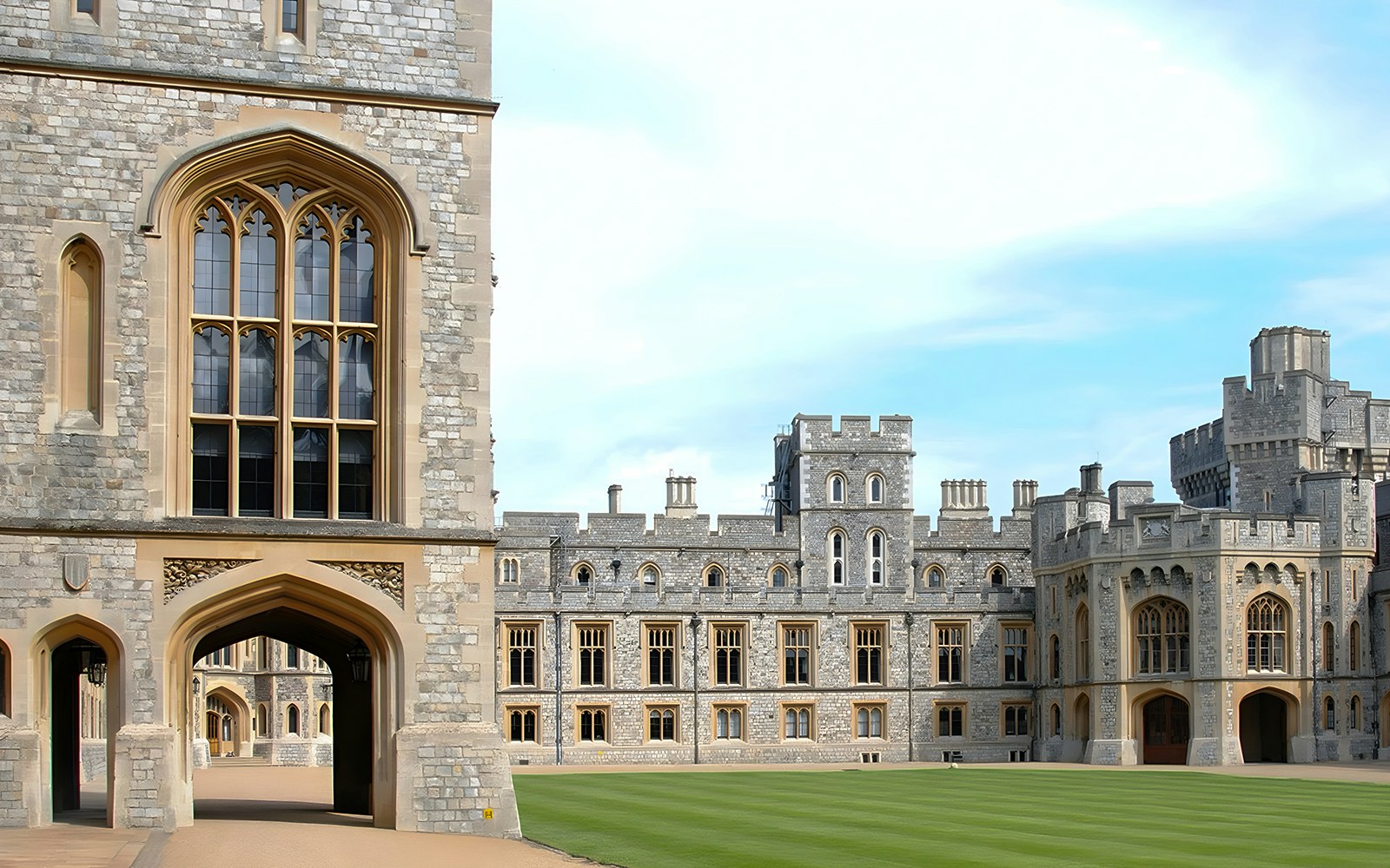 Windsor Castle Grounds with historic stone architecture and green lawn.