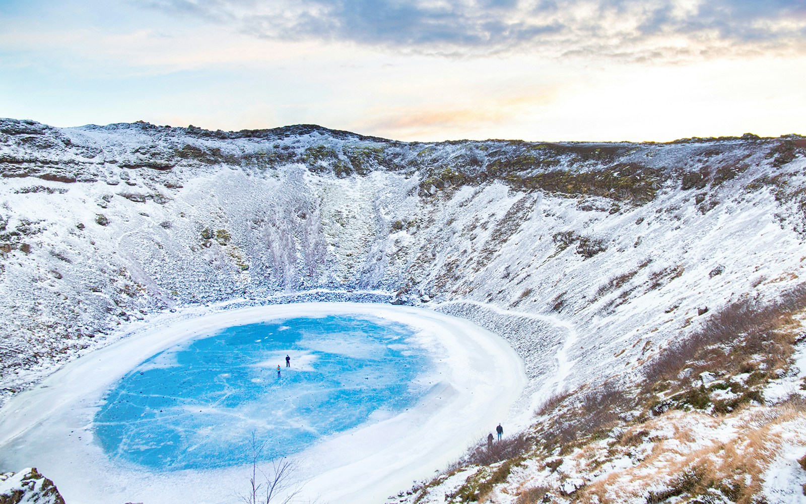 Kerid Crater Lake in Iceland covered in snow during winter.