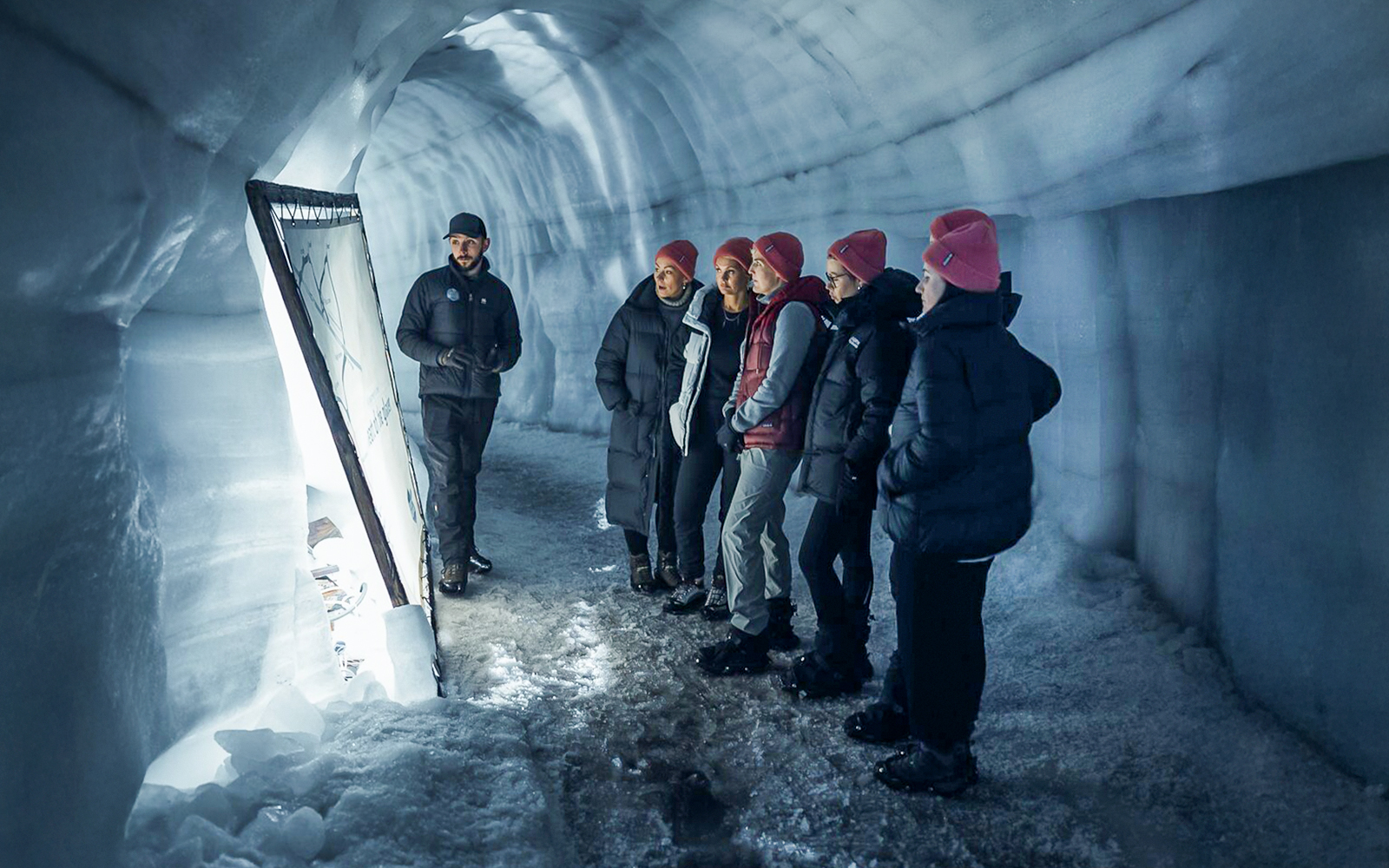 Guests with tour guide inside Langjokull ice tunnels in Iceland.