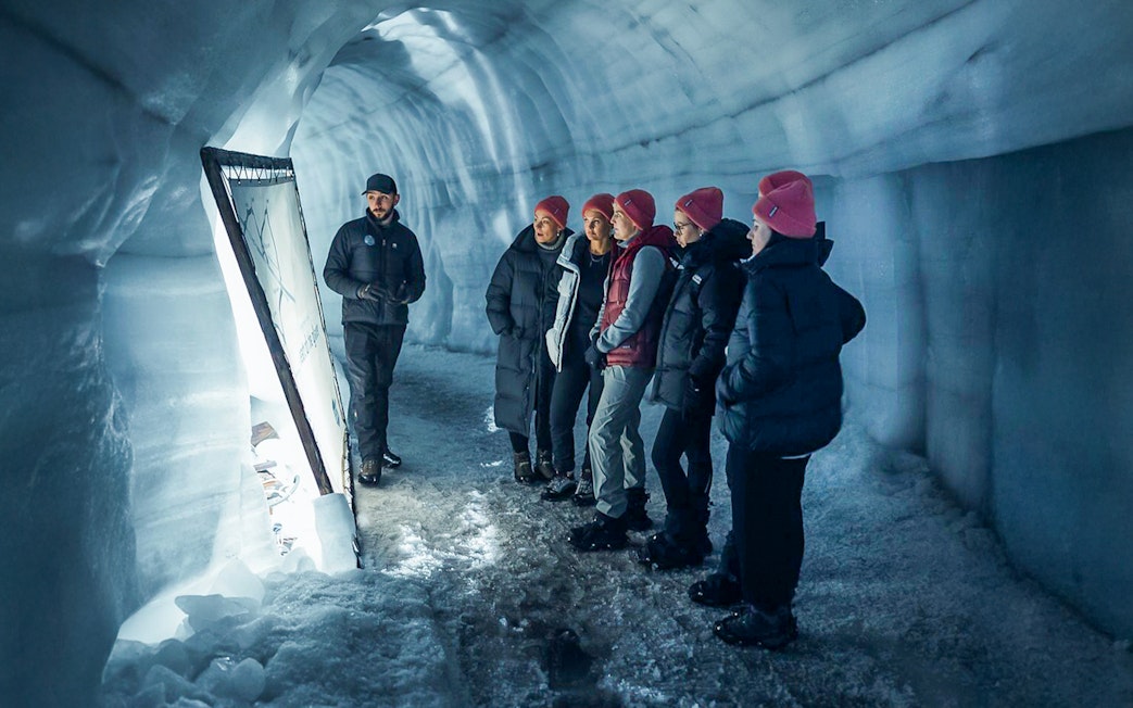 Guests with tour guide inside Langjokull ice tunnels in Iceland.