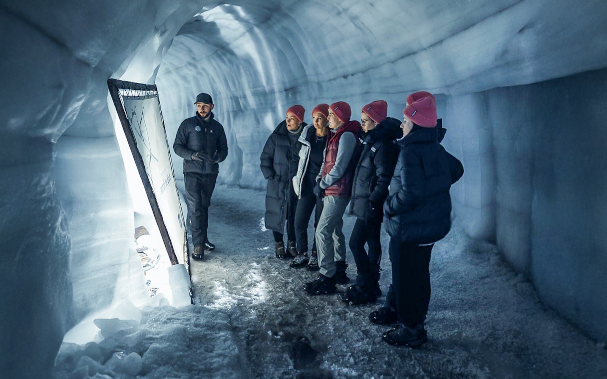 Guests with tour guide inside Langjokull ice tunnels in Iceland.