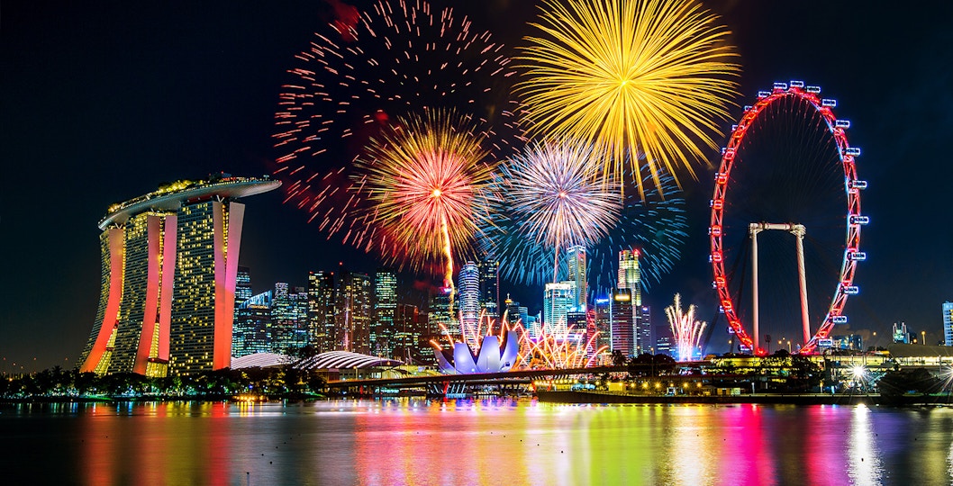 Fireworks over Marina Bay Sands and Singapore Flyer during New Year’s Eve in Singapore.