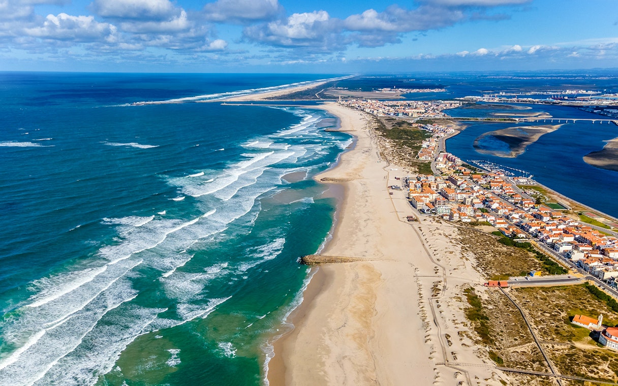 Aerial view of Aveiro coastline with sandy beaches and ocean waves, Portugal.