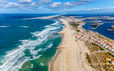 Aerial view of Aveiro coastline with sandy beaches and ocean waves, Portugal.
