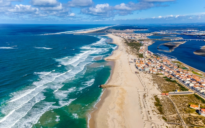 Aerial view of Aveiro coastline with sandy beaches and ocean waves, Portugal.