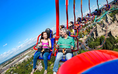 Riders on WindSeeker at Canada's Wonderland with park view.