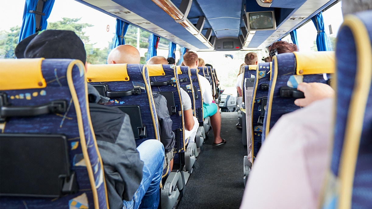 Passengers boarding a tour bus in Paris, France, for a city sightseeing experience.
