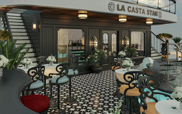 Luxury cruise deck with elegant seating and floral decor on La Casta Star, Lan Ha Bay.