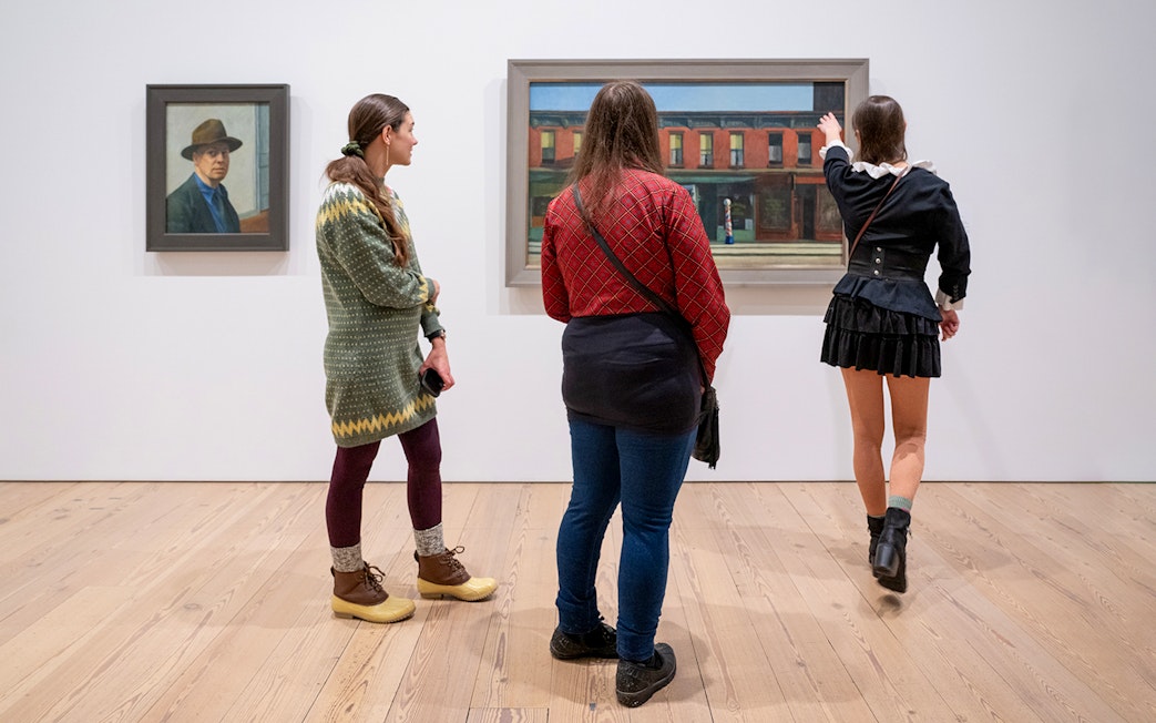 Guests viewing paintings at Whitney Museum of American Art.