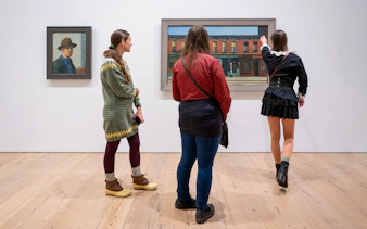 Guests viewing paintings at Whitney Museum of American Art.