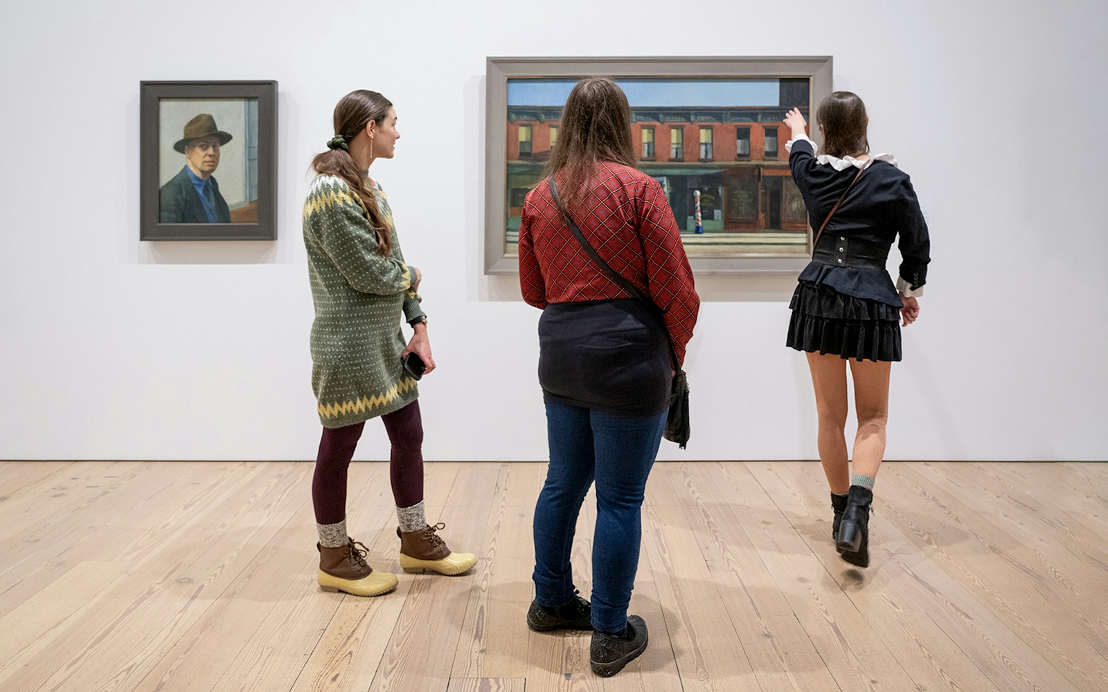 Guests viewing paintings at Whitney Museum of American Art.