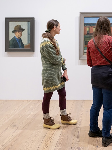Guests viewing paintings at Whitney Museum of American Art.