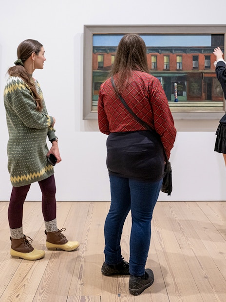 Guests viewing paintings at Whitney Museum of American Art.