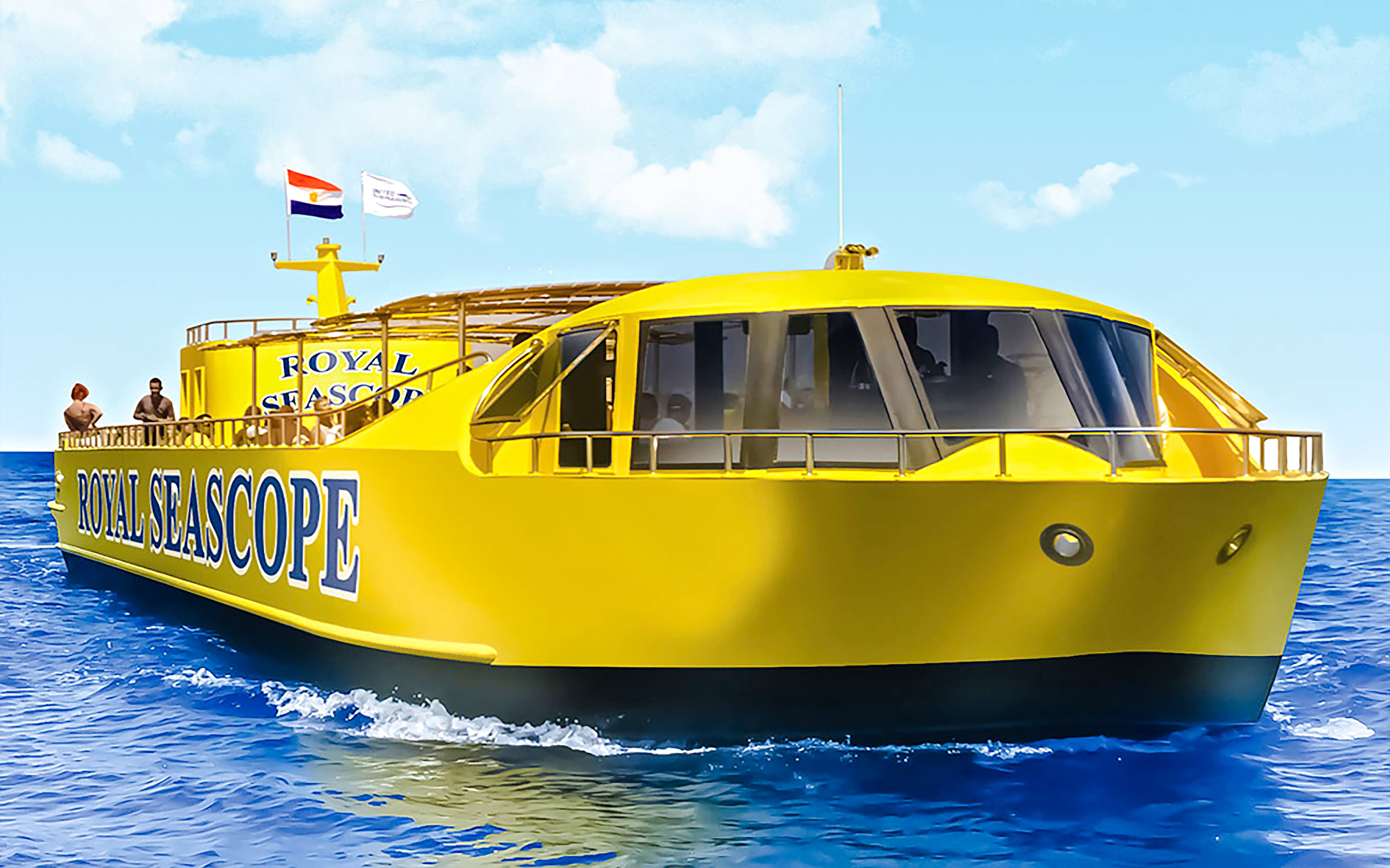 Royal Seascope yellow submarine cruise on blue ocean with passengers on deck.