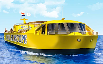 Royal Seascope yellow submarine cruise on blue ocean with passengers on deck.
