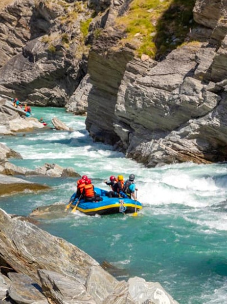 Whitewater rafting on Shotover River, Queenstown, navigating rocky canyon.