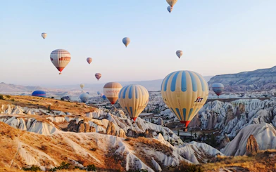 Hot air balloons over Cappadocia's unique rock formations, Turkey.