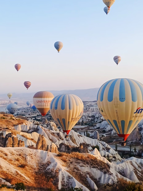 Hot air balloons over Cappadocia's unique rock formations, Turkey.