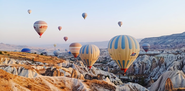Hot air balloons over Cappadocia's unique rock formations, Turkey.