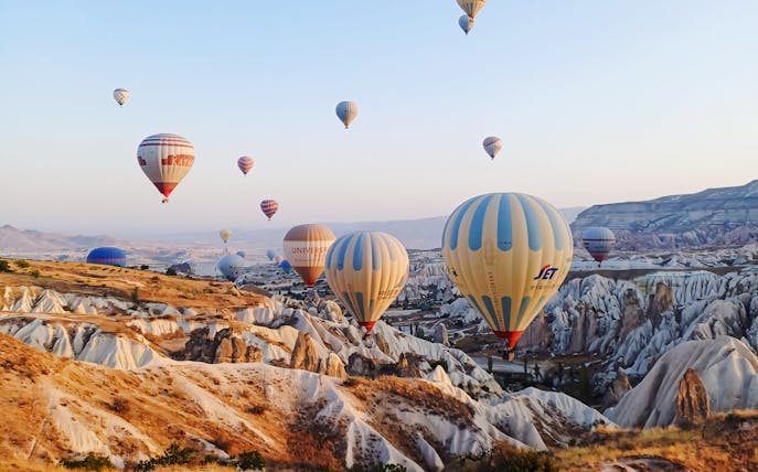 Hot air balloons over Cappadocia's unique rock formations, Turkey.