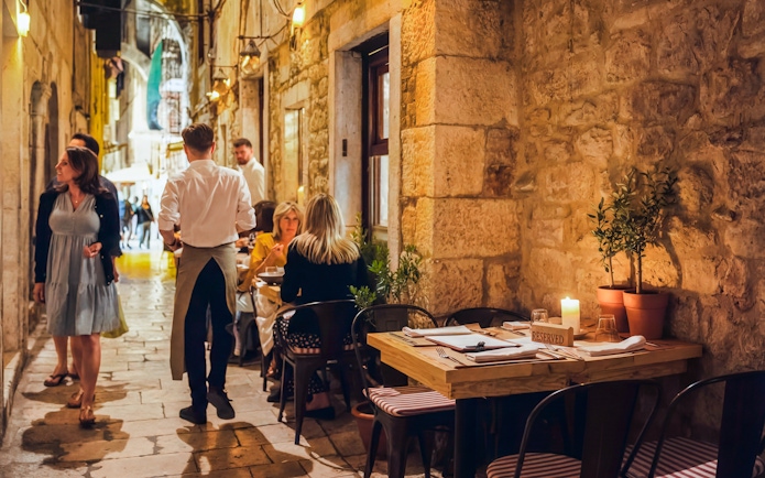 Wine tasting setup in a historic alley of Diocletian’s Palace, Split, Croatia.