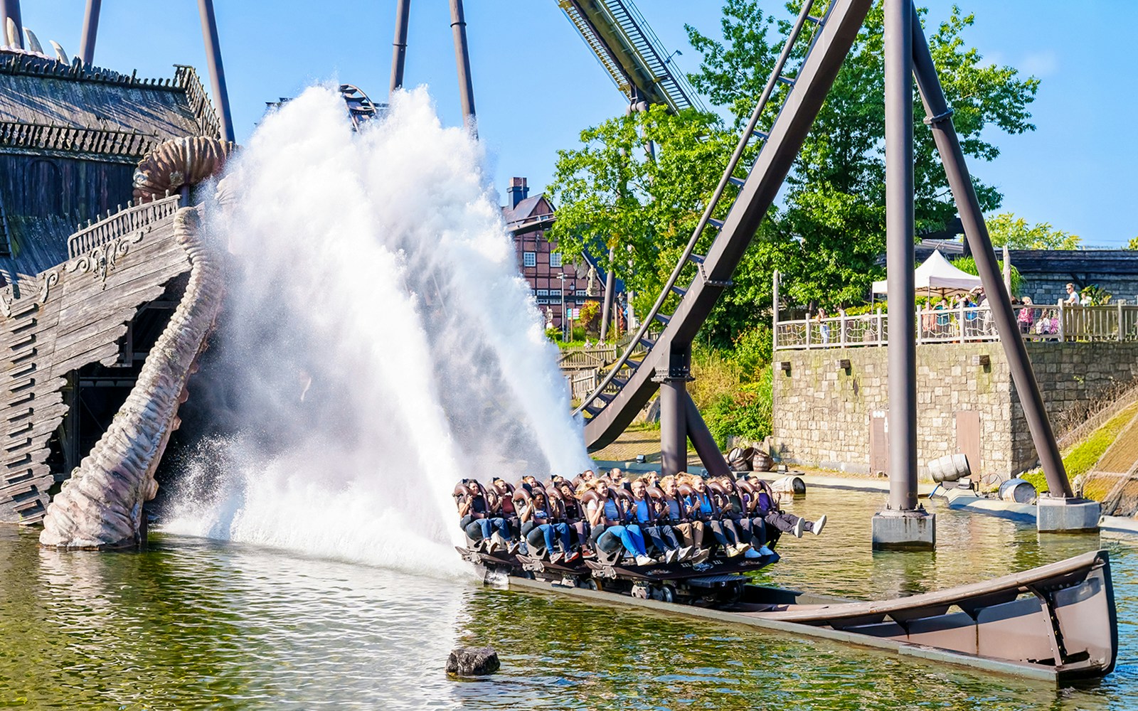Rollercoaster riders splash through water on The Kraken at Heide Park Resort.