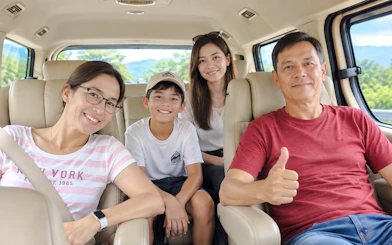 Family enjoying a private van transfer from Chiang Mai to Sukhothai City.