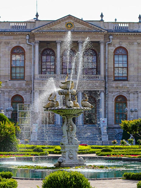 Fountain in front of Dolmabahçe Palace, Istanbul, surrounded by gardens.