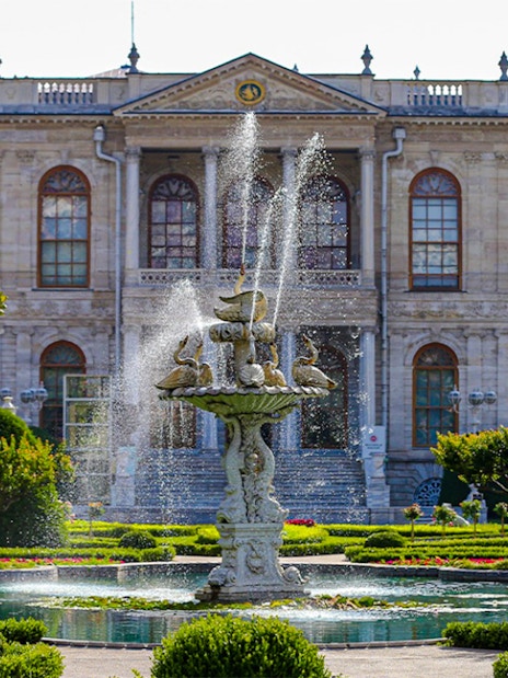 Fountain in front of Dolmabahçe Palace, Istanbul, surrounded by gardens.